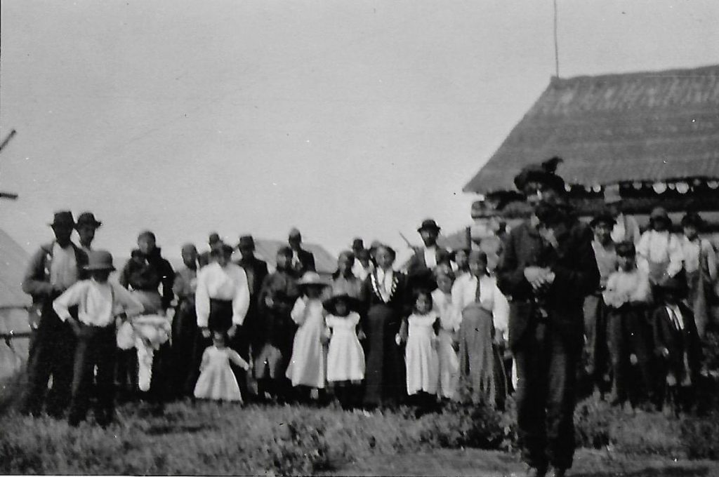 black and white image of Chief Wasagejig and BNA members in background